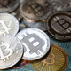 This illustration photograph taken on July 19, 2021 in Istanbul shows a physical banknote and coin imitations of the Bitcoin crypto currency.